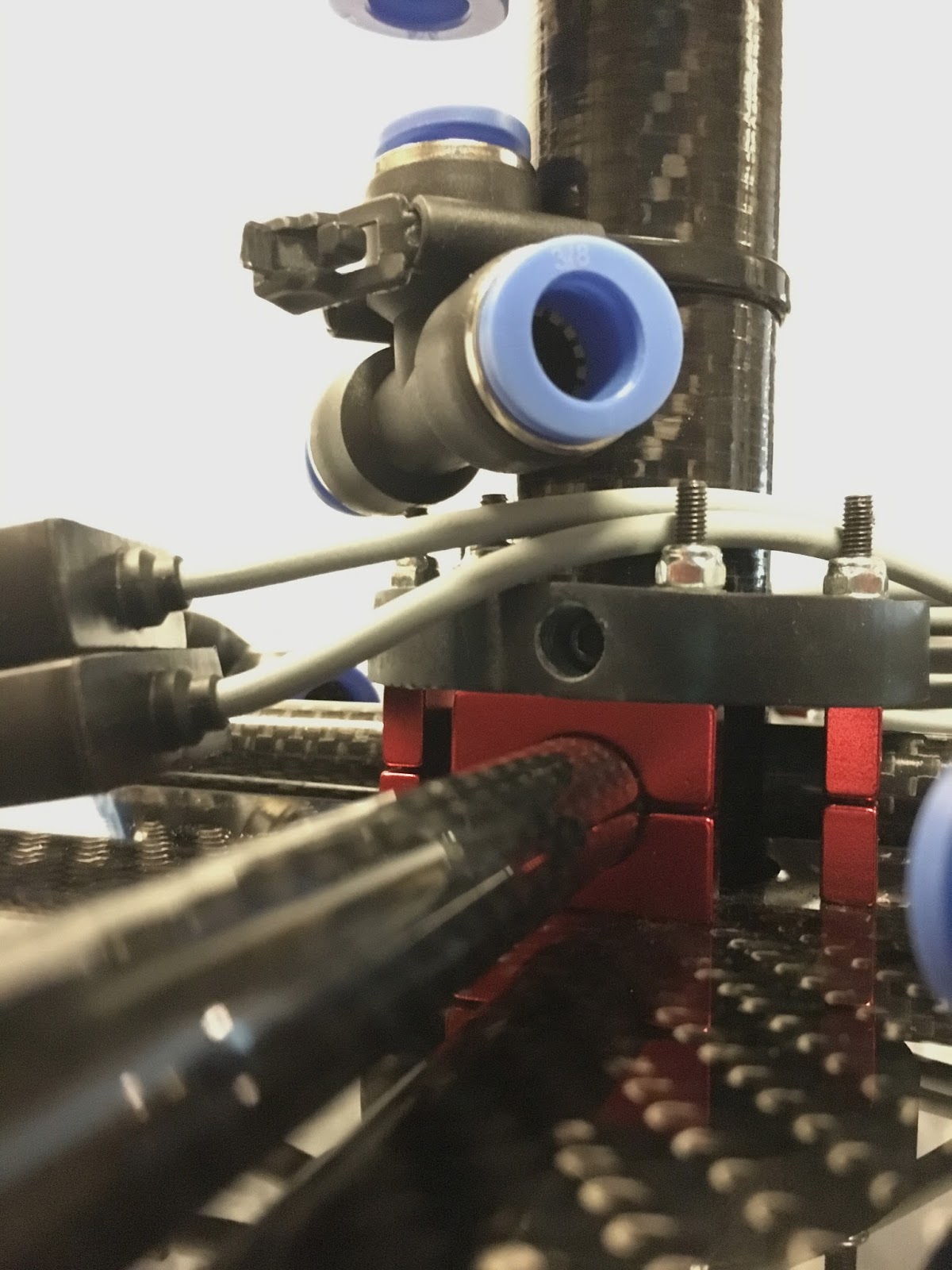 Jet arm inboard brackets with upper mounting ring (dark 3D-printed resin with through bolts)